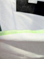 Neon side seam detail on UNBOUGHT football tee