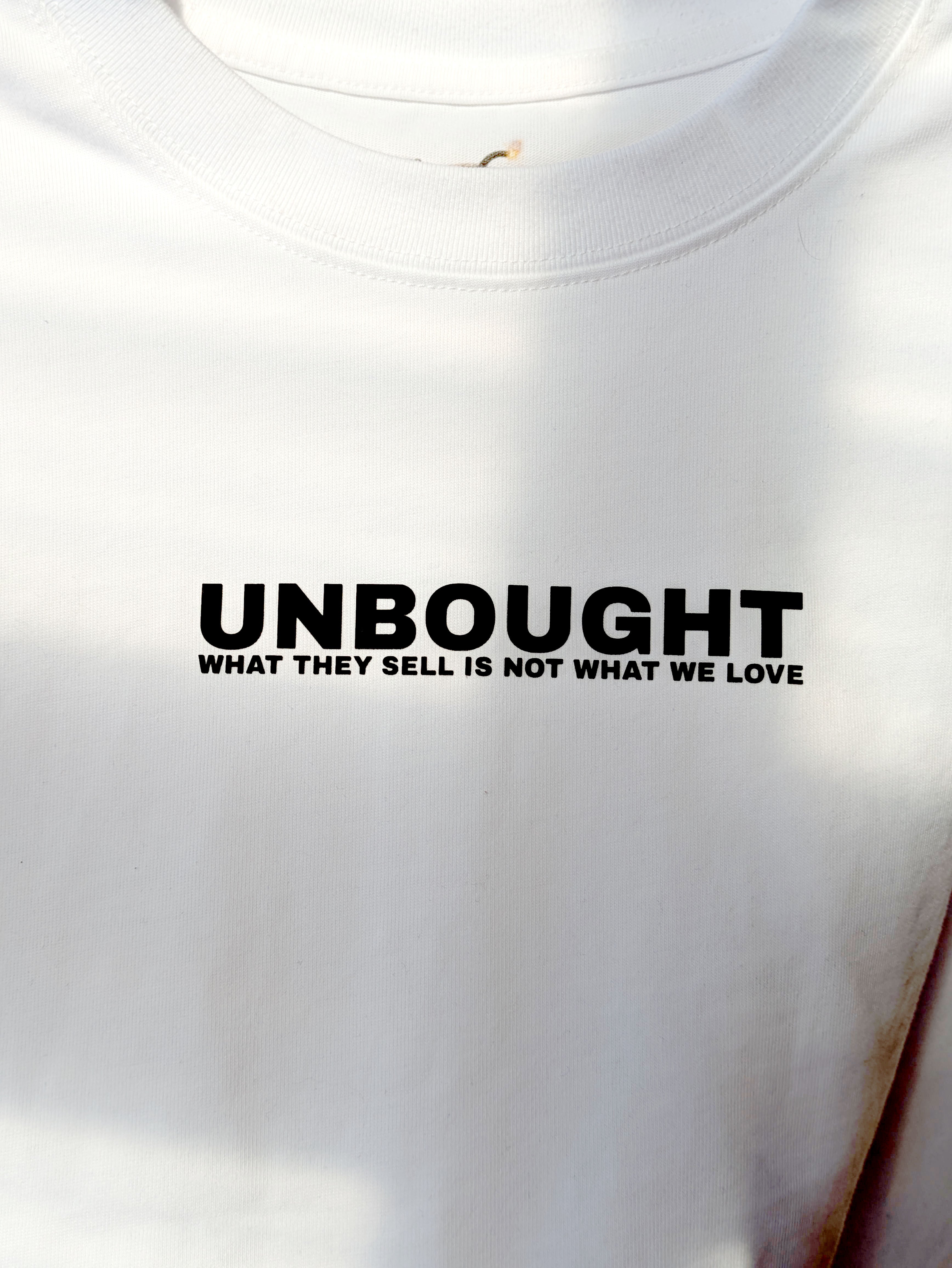 Neon side seam detail on UNBOUGHT football tee